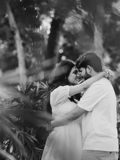 A duplicate of image 8, a beautiful black and white shot of a couple embracing in a garden.