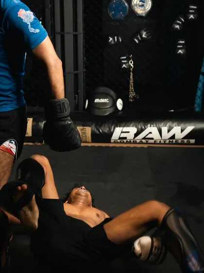 A fighter lies on the mat after a tough round of sparring, a common sight in the "Everyday Porrada" mindset.