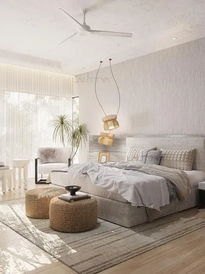 A bedroom composed for stillness and layered in softness. Filtered sunlight, woven pendant light fixtures, and a soothing neutral color palette create a perfect sanctuary for rest.