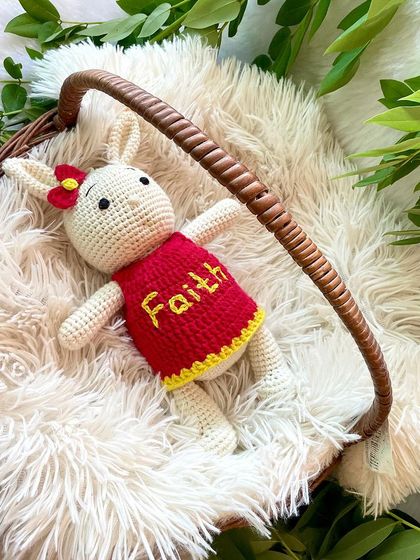 This bunny in a bright red and yellow dress is personalized with the name "Faith". The vibrant colors make her so cheerful and fun.