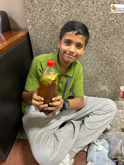 A student holds up his finished bottle of bio-enzyme. He has not only learned a new skill but also created a useful, eco-friendly product for plants.