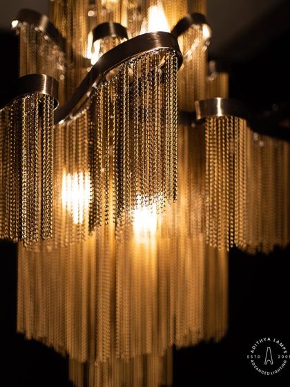 This chandelier makes a bold statement with its cascading antique gold chains. The layers of chains create a fluid, waterfall-like effect that beautifully diffuses the light, adding texture, warmth, and a touch of vintage glamour to your interior.