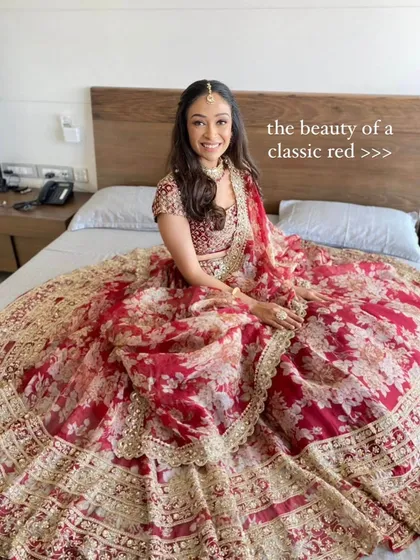 The timeless beauty of a classic red lehenga. This bride looks absolutely radiant in a floral red organza lehenga, a perfect blend of traditional color and modern design.