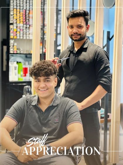 A staff appreciation post featuring one of our stylists with a happy client. We celebrate the artists who are the heart of our salon.