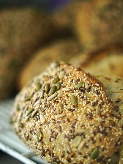 A close-up of our freshly baked seeded country loaf. The crust is packed with a variety of seeds, adding texture, flavor, and nutritional value to every slice.