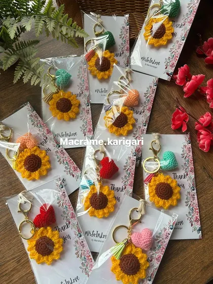 A collection of our sunflower and heart keychains, prepared for a bulk order. We take great care in packaging each one to make it special.