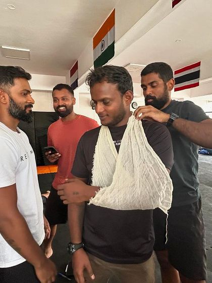 Students practicing how to create a makeshift arm sling for injuries.