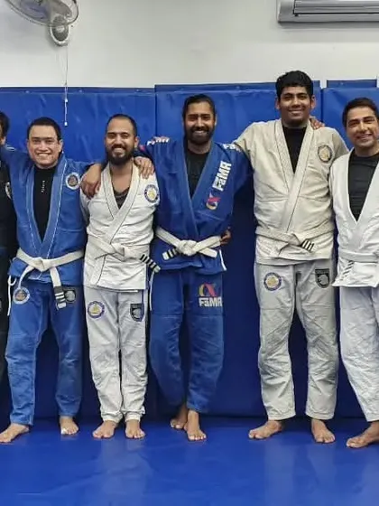 A small group of training partners after a session. These are the moments where we connect, discuss techniques, and build the trust that is essential in Jiu-Jitsu.