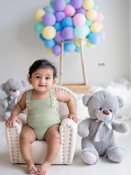 An "Up" inspired photoshoot! The balloon hot air balloon and teddy bear create a whimsical and adventurous theme.