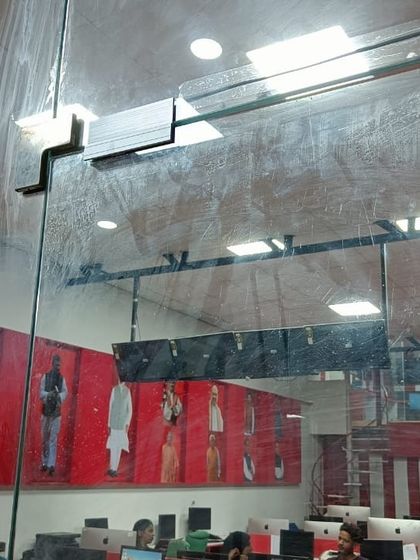 A view from inside an office showing the glass door with the installed EM lock bracket. The system is discreet yet provides robust security for the workspace.