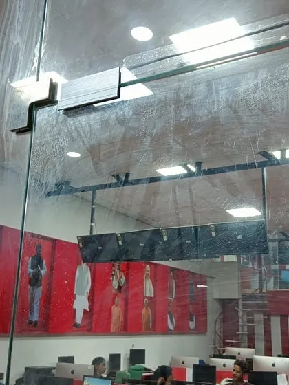 A view from inside an office showing the glass door with the installed EM lock bracket. The system is discreet yet provides robust security for the workspace.