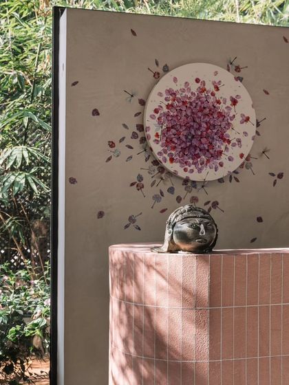 Detail of the bar area, with a small sculpture sitting atop the pink brick counter. This highlights our approach of curating art and objects to personalize each space.