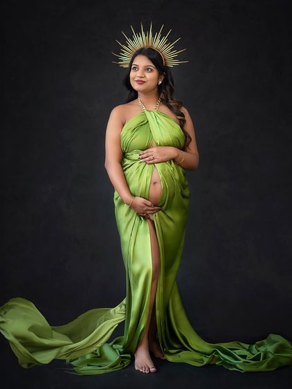 A full-length view of the green goddess gown, showing how a simple drape can create such a dramatic and regal effect.