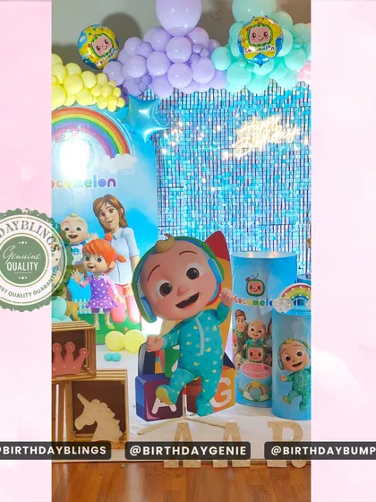 A detail shot of the Cocomelon party, focusing on the character cutouts and themed wooden crates used for decoration.