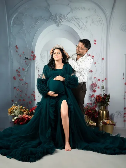 Crowning his queen. This playful yet loving gesture adds a touch of royalty and fun to the maternity session, celebrating the mom-to-be.