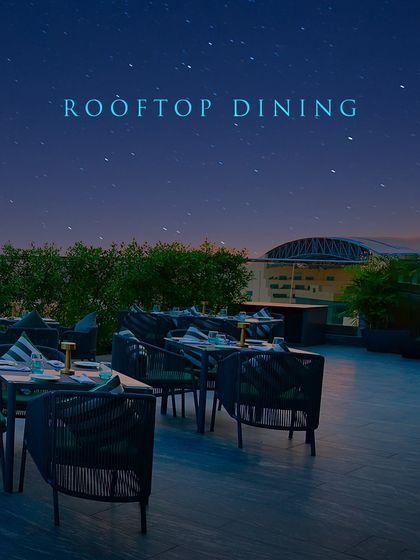 Showcasing the promise of rooftop dining at its finest, with comfortable seating and an unparalleled view.