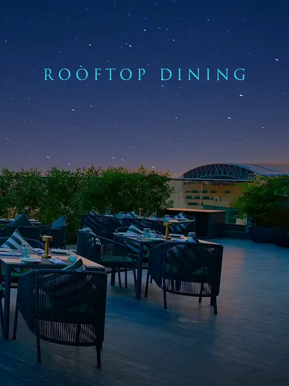 Showcasing the promise of rooftop dining at its finest, with comfortable seating and an unparalleled view.