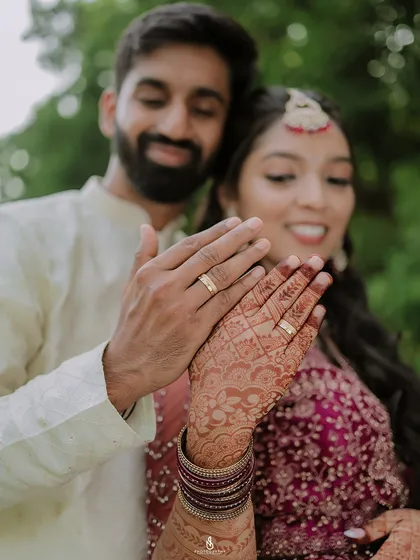 The small details are a big part of your story. Here, I've focused on the wedding rings and intricate mehndi design, symbols of a new beginning.