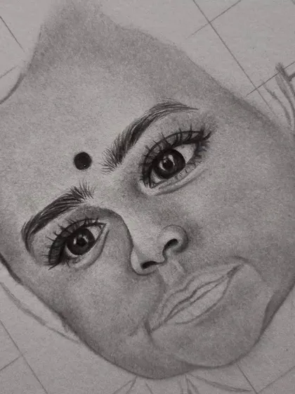 The work-in-progress for this baby portrait, showing how I carefully sketch the eyes and facial features using a grid before adding shading.