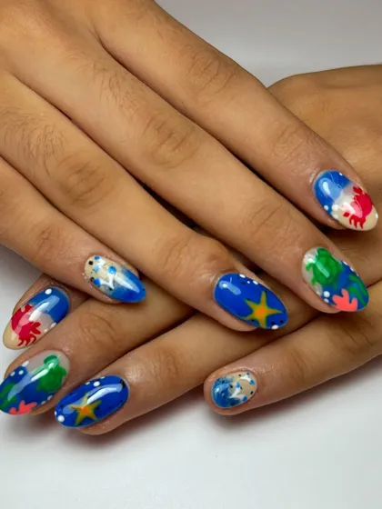 The complete ocean lover's set, showcasing all the different hand-painted sea creatures and elements. Each nail is a unique piece of art that contributes to the overall theme.