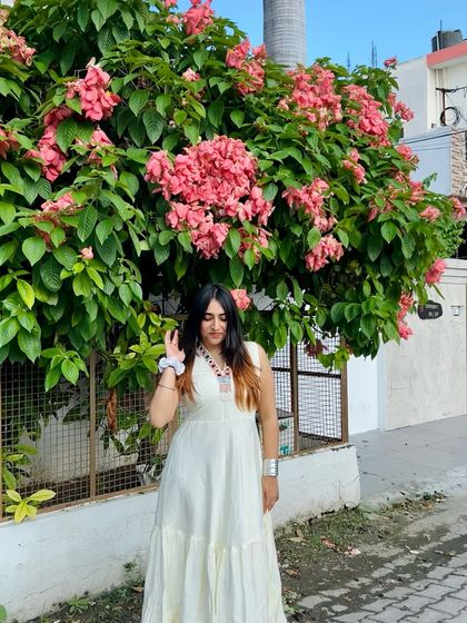 A slightly different pose in the white maxi dress. This shows the subtle movement and flow of the dress.
