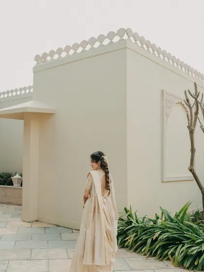 A beautiful shot of the bride in her elegant South Indian Haldi attire, showcasing the simplicity and grace of her look.