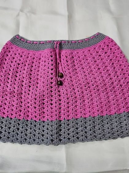 The matching skirt from the 'Lil Pink Coord Set,' featuring a drawstring waist with wooden beads. It's designed to be comfortable and easy to wear.