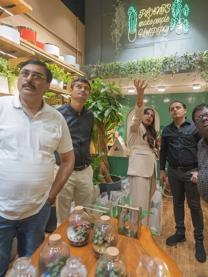 I love showing clients around the studio and helping them discover new plants. Here, I'm pointing out some of our hanging plant varieties to a group visiting the store.