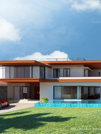 The front elevation of this modern home shows the clean composition of white render, wood-clad soffits, and expansive glass walls. The design prioritizes an open, airy feeling and a direct connection to the landscaped garden.