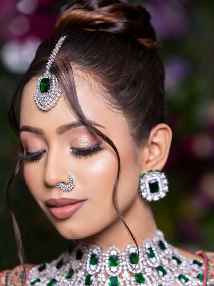 A close-up of the new-age bride with her eyes closed, showcasing the perfectly blended eyeshadow and flawless base.