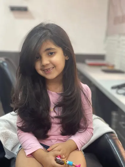 I make sure even my youngest clients leave with a smile. This adorable little one got a beautiful, long-layered haircut that's easy to manage and looks absolutely precious.