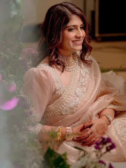 An absolute dream look for a reception. The makeup is soft and ethereal, complementing the delicate organza saree perfectly.