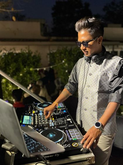 Mixing live during a Baraat procession. I stay connected to the crowd's energy, adjusting the music to keep the party going strong.
