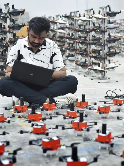 Every show begins with meticulous planning and programming. Here, one of our engineers is surrounded by our drone fleet, fine-tuning the choreography for a large-scale performance. This level of precision ensures every drone moves in perfect harmony.