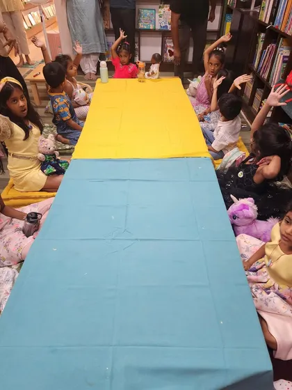 Little hands shoot up, full of excitement and ready to participate. This photo captures the interactive nature of our parties, where every child is encouraged to join in the fun.