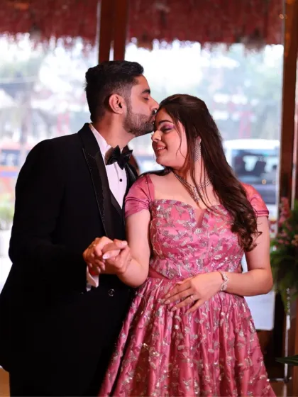 An intimate forehead kiss. The bride's makeup is soft and romantic, designed to look beautiful in close-up, emotional moments.