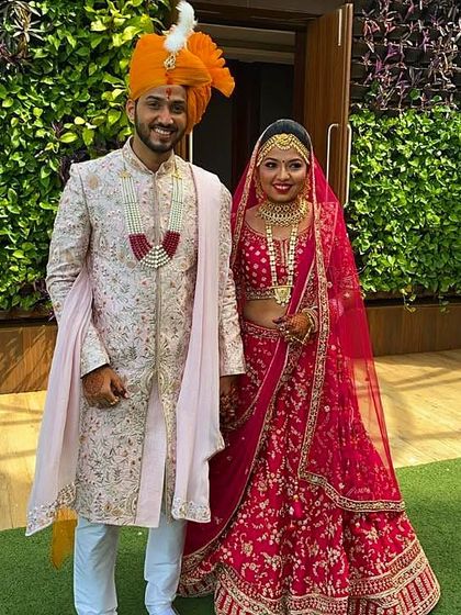 This groom is wearing a custom baby pink sherwani made from raw silk fabric. The entire piece features all-over hand and machine work and is styled with a georgette dupatta for a soft, elegant look.