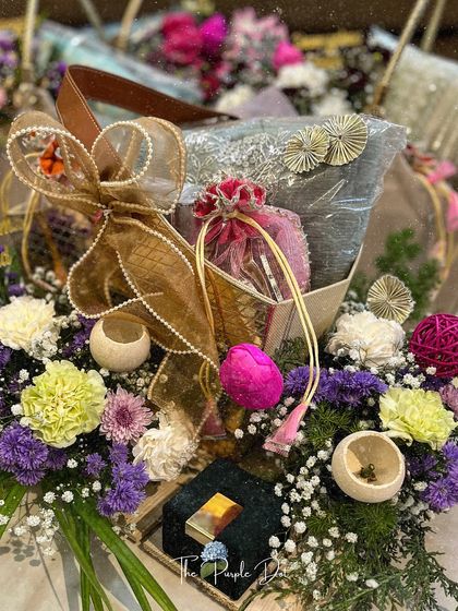 A closer look at a 'ZarGul' hamper, where textures and details come together. A beautiful pearl-studded bow, colorful florals, and carefully selected items create a gift that is truly unforgettable.