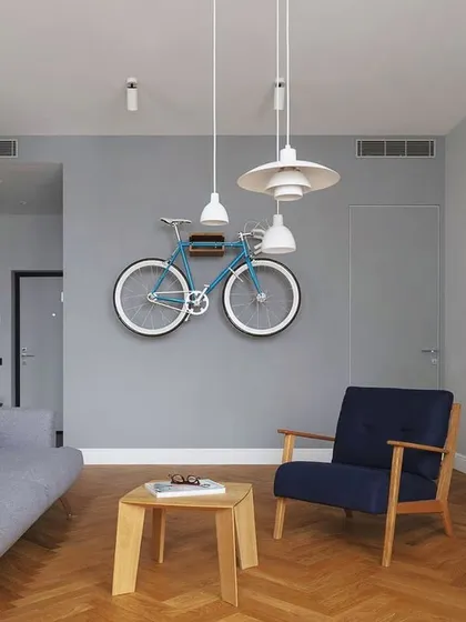 Greys and tan browns are a great combination for any space. This living room concept uses these colors to create a calm, modern, and joyful atmosphere, with a unique bicycle wall art piece.