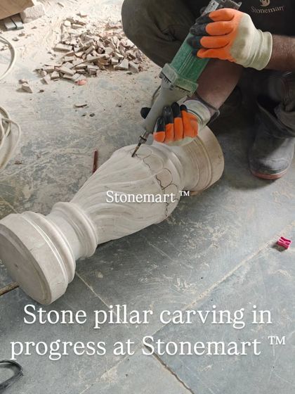 An artisan carves intricate patterns onto a stone pillar. This level of detail is what makes each piece a unique work of art.
