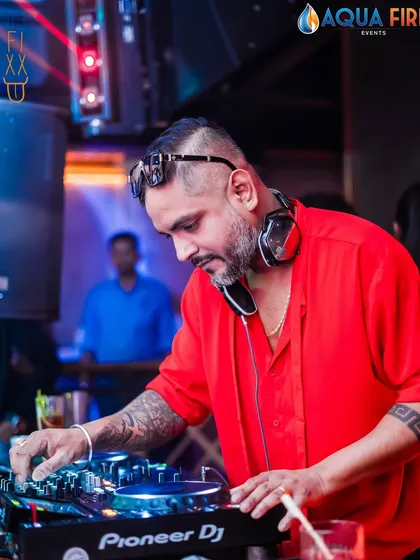 In the zone, crafting the perfect mix. Every track is chosen to build the energy and keep the dance floor packed. Here's a close-up of me at the Pioneer decks during a high-energy set at The Fixx.