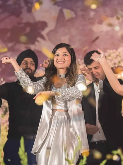 The whole family comes together for a finale, showering the stage with confetti. We help create a memorable end to the sangeet.