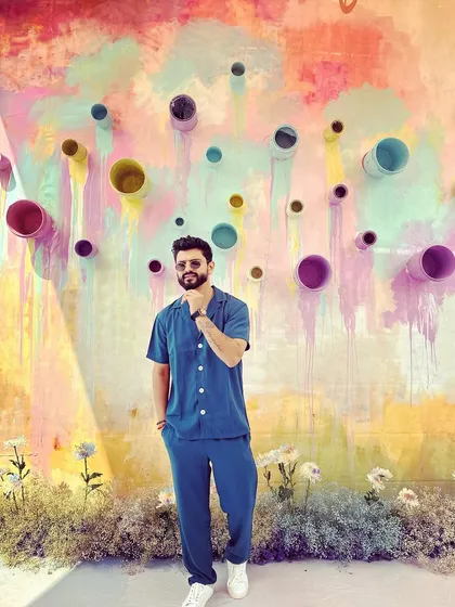 Spreading happiness and colors in this blue co-ord set against a vibrant, artistic wall.