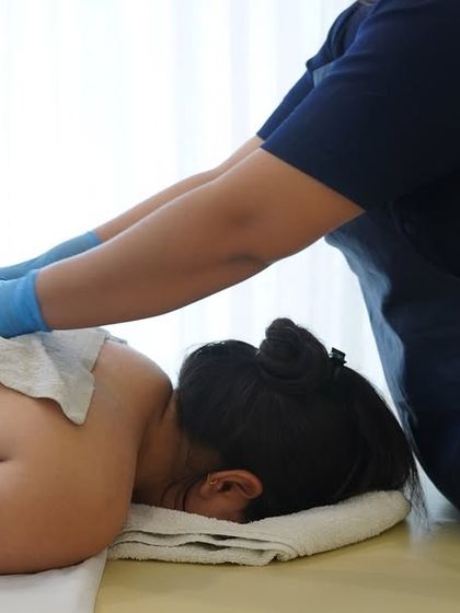 The treatment continues with the removal of the scrub using a warm, damp cloth. This step reveals the fresh, smooth skin underneath and prepares it for hydration.