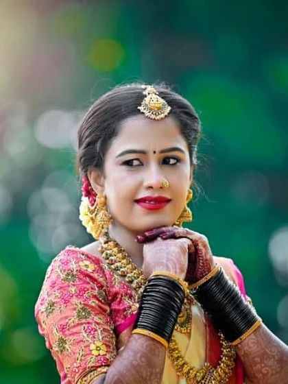 A happy, candid moment. The makeup is designed to look flawless even in bright, natural light, highlighting her joyful expression.