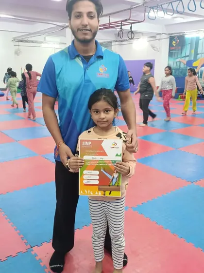 Another happy student is recognized for her progress with a certificate.
