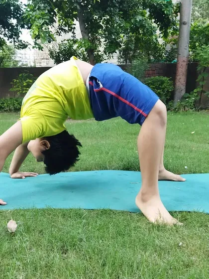 Flexibility training is for everyone. This young champion is working on his back bridge, a gymnastics move we use to develop full-body strength and coordination.
