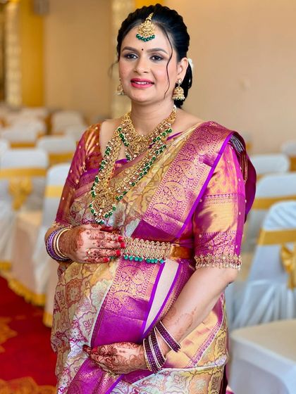 A closer look at the flawless HD makeup for Usha's baby shower. The focus is on luminous skin, defined eyes, and a lip color that complements her entire ensemble.