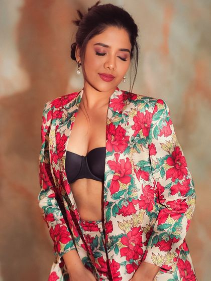 A close-up of Karunya's makeup with her eyes closed. The soft pink eyeshadow and glowing skin create a fresh and youthful look.