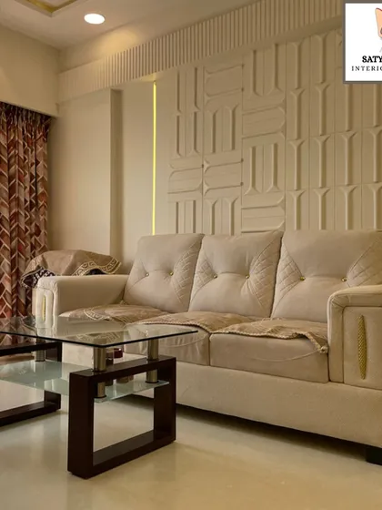 A close-up of the comfortable, tufted sofa set against the geometric wall paneling, a perfect example of calm and classic design.